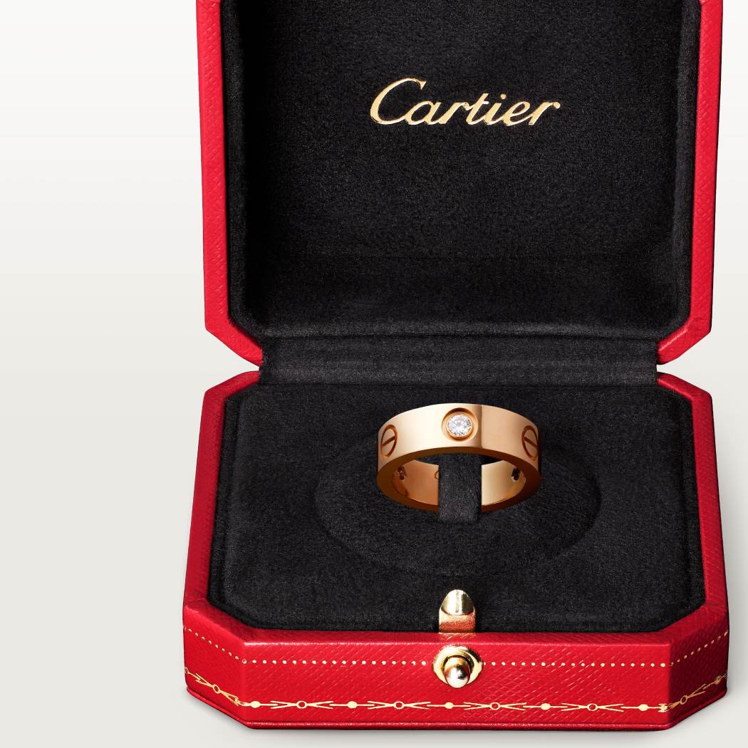 Cartier classic 18K rose gold LOVE ring adorned with three diamonds