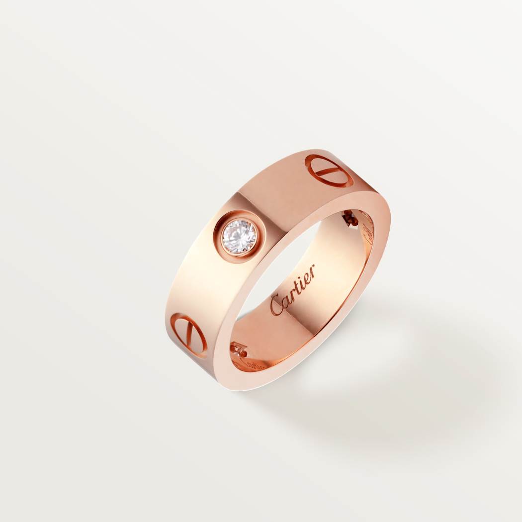 Cartier classic 18K rose gold LOVE ring adorned with three diamonds