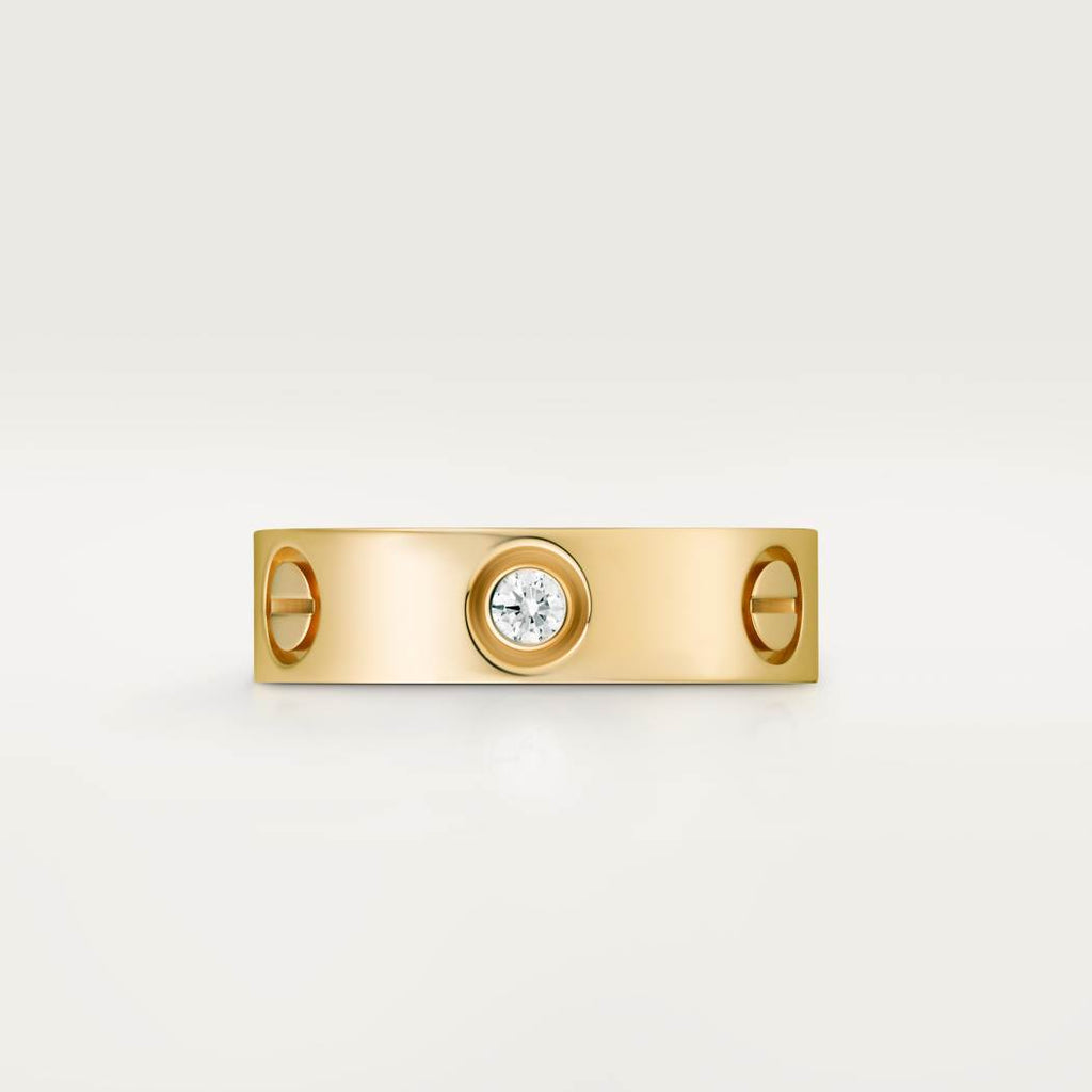Cartier classic 18K gold LOVE ring adorned with three diamonds