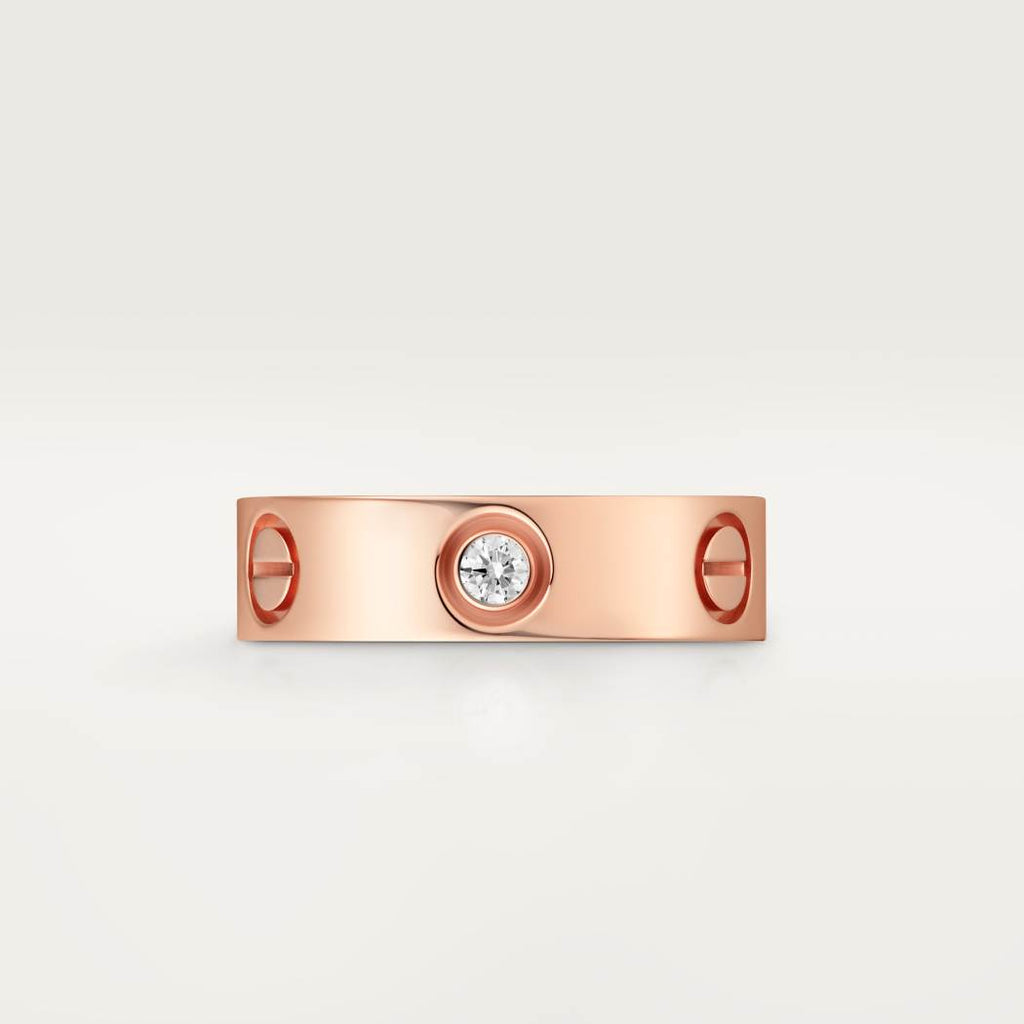 Cartier classic 18K rose gold LOVE ring adorned with three diamonds