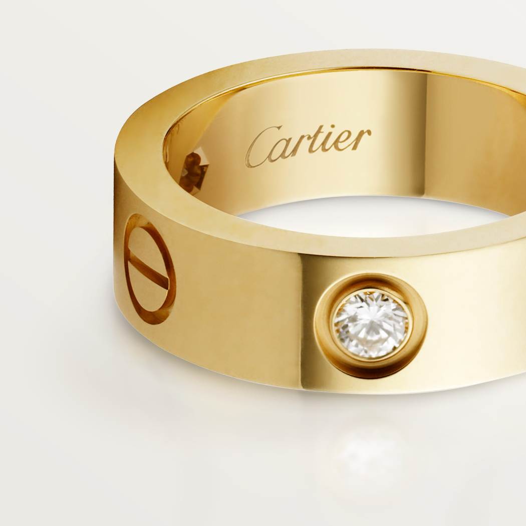 Cartier classic 18K gold LOVE ring adorned with three diamonds