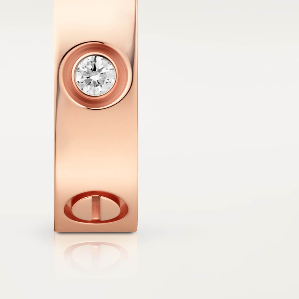 Cartier classic 18K rose gold LOVE ring adorned with three diamonds