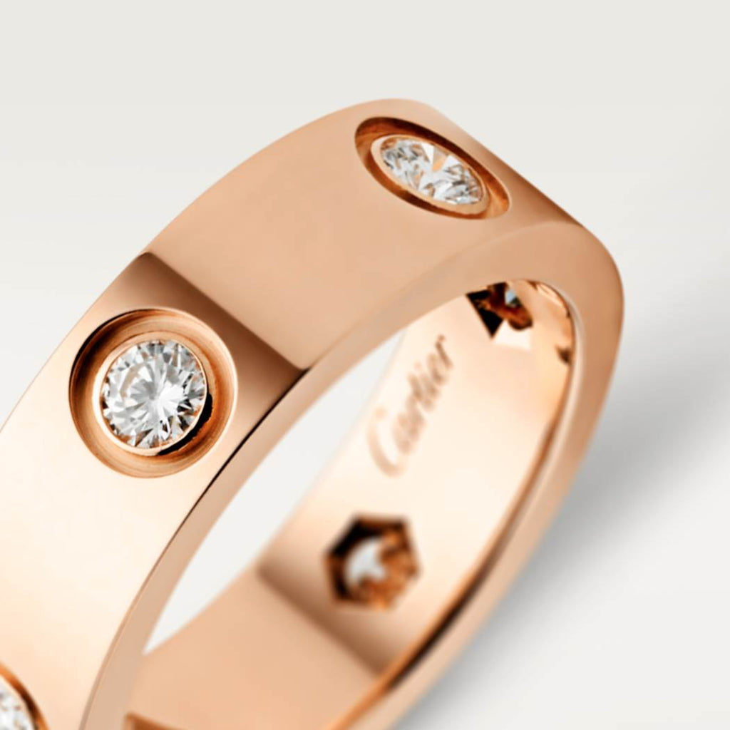 Cartier classic 18K rose gold LOVE ring adorned with six diamonds