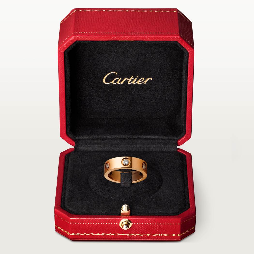 Cartier classic 18K rose gold LOVE ring adorned with six diamonds