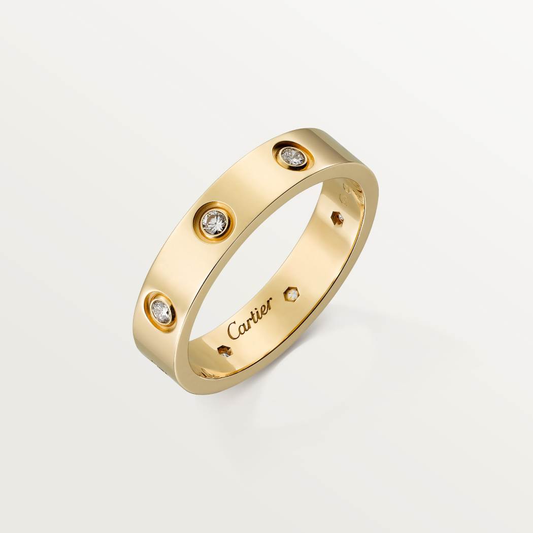 Cartier classic 18K gold LOVE ring adorned with eight diamonds