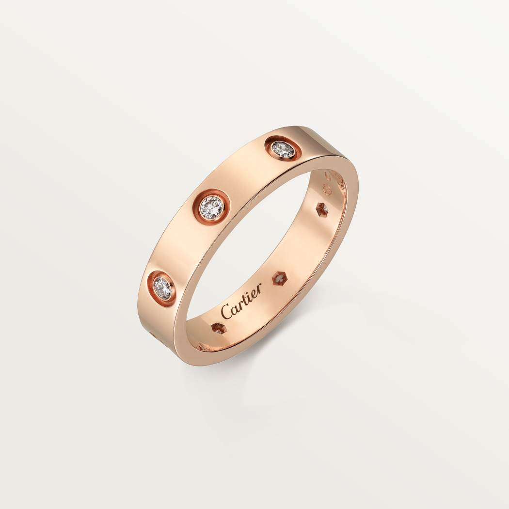 Cartier classic 18K rose gold LOVE ring adorned with eight diamonds