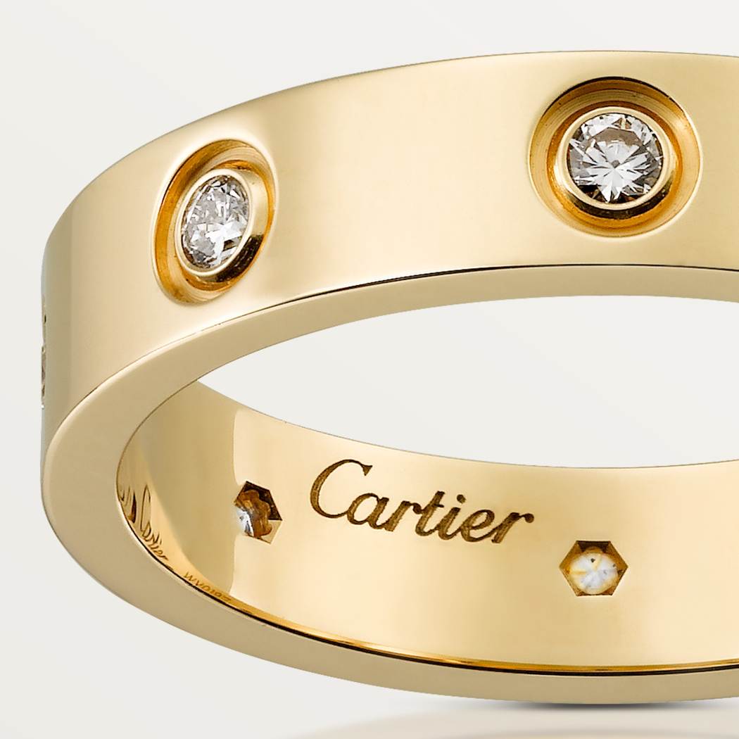 Cartier classic 18K gold LOVE ring adorned with eight diamonds