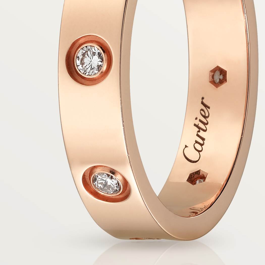 Cartier classic 18K rose gold LOVE ring adorned with eight diamonds
