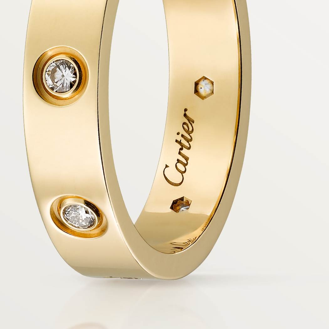 Cartier classic 18K gold LOVE ring adorned with eight diamonds