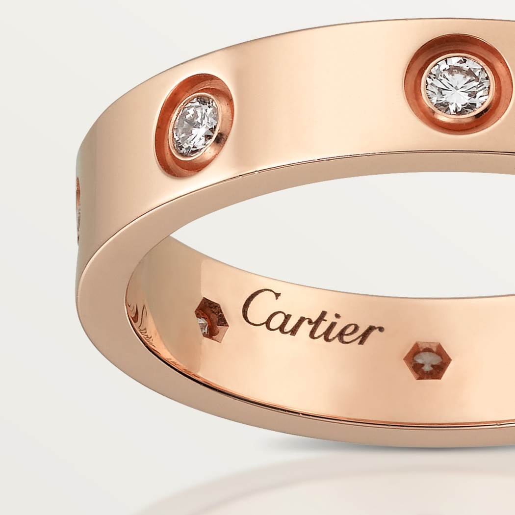 Cartier classic 18K rose gold LOVE ring adorned with eight diamonds