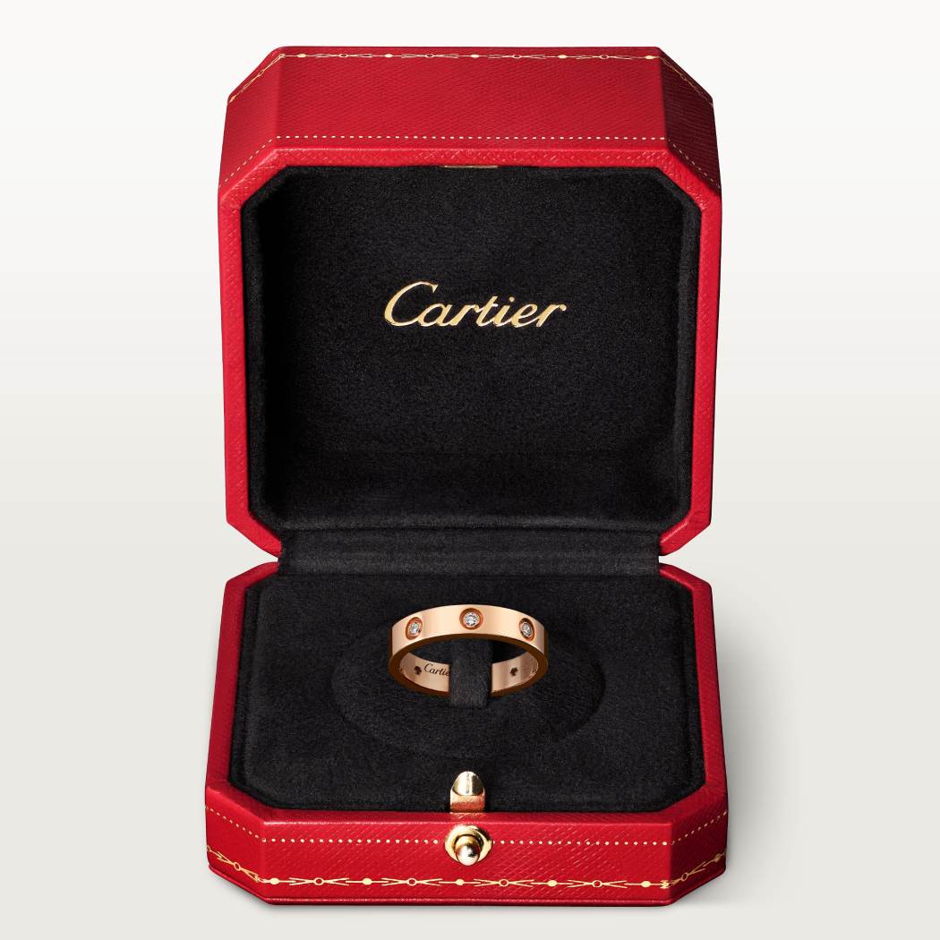 Cartier classic 18K rose gold LOVE ring adorned with eight diamonds