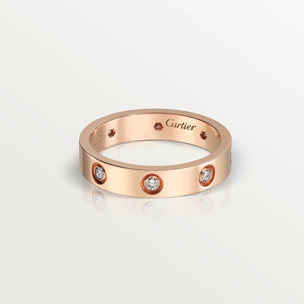 Cartier classic 18K rose gold LOVE ring adorned with eight diamonds